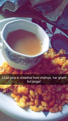 a white plate topped with fried food and a cup of tea on top of it