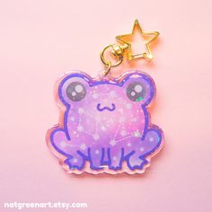 a purple frog keychain with a star on it