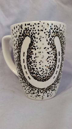 a coffee cup with black and white designs on it