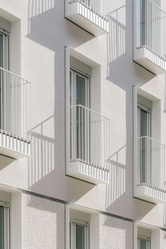 several balconies on the side of a building with windows and balconies