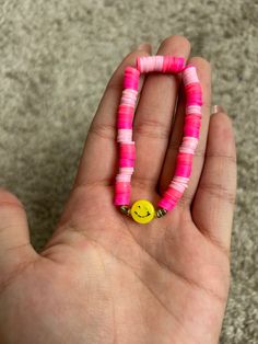 Made with durable string this bracelet is very pink and cheery. This smiley face is going to keep a smile on your face. Fair warning the black may fade overtime with exposure to water. Fun Black Friendship Bracelets, Pink Smiley Face Jewelry For Everyday, Pink Smiley Face Round Bead Jewelry, Pink Smiley Face Round Beaded Jewelry, Adjustable Smiley Face Fun Bracelet, Playful Pink Bracelets For Everyday, Adjustable Pink Jewelry With Smiley Face, Playful Pink Bracelet For Everyday, Handmade Pink Friendship Bracelets Cheerful Style