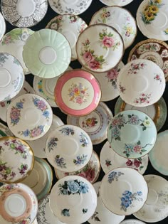 an array of china plates and saucers are stacked on top of eachother