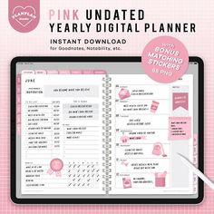 the pink undated year - by - date planner is displayed on a tablet screen