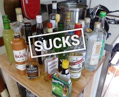 a wooden shelf filled with lots of liquor bottles