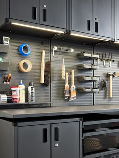 there are many tools on the wall in this garage storage area that is organized and organized