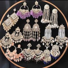 several different types of earrings are displayed on a plate