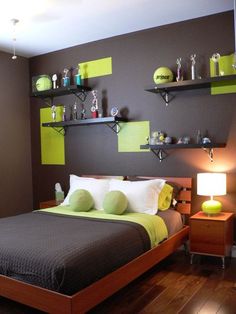 a bed room with a neatly made bed and two shelves on the wall above it