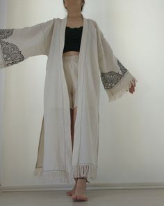 Embrace your bohemian  spirit with our Handmade Boho Kimono, featuring beautiful fringe details and intricate mandala designs. This unique open front cardigan is perfect for layering over your favorite outfits, adding a touch of elegance and artistic flair. Crafted with care, this kimono combines comfort with style, making it an essential piece for any boho-chic wardrobe. Features: *Intricate Mandala Design: Handcrafted with detailed mandala patterns on the sleeves and back, adding a unique artistic touch. *Fringe Details: Elegant fringe along the hem and sleeves enhances the bohemian vibe and adds movement to your look. *High-Quality Fabric: Made from soft, durable fabric for ultimate comfort and long-lasting wear. *Versatile Fit: Open front design allows for easy layering, suitable for v Bohemian Fringe Outerwear For Summer, Bohemian Fringe Cardigan For Festivals, Bohemian Spring Cardigan With Tassels, Festival Long Sleeve Kimono With Fringe, Bohemian Cotton Outerwear With Tassels, Bohemian Long Outerwear With Tassels, Long Bohemian Outerwear With Tassels, Bohemian Summer Outerwear With Tassels, Long Sleeve Festival Kimono With Fringe