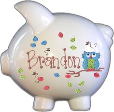 a ceramic piggy bank with an owl and bird on it's back that says brandon