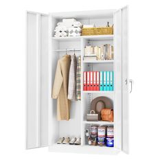 an open white closet with clothes, books and other items on the shelves next to it