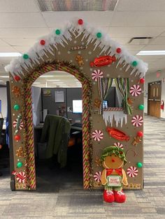 an office cubicle decorated with gingerbreads, candy canes and christmas decorations