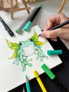 someone is drawing a frog with colored pencils