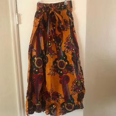 Printed Maxi Skirt- Plus Size- One Fits Most Casual Multicolor High Waist Maxi Skirt, Orange Midi Skirt For Beach, Casual Yellow Wide Leg Skirt, Casual Wide Leg Yellow Skirt, Casual Summer Wrap Skirt With Wide Legs, Brown Floral Print Beach Bottoms, High Waist Brown Maxi Skirt For Summer, Brown High-waisted Maxi Skirt For Summer, Brown High Waist Maxi Skirt For Summer