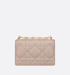 The Miss Caro mini bag enhances the Dior Caro line with modern and timeless elegance. Crafted in two-tone trench beige lambskin, it stands out with the unique quilted effect of Macrocannage stitching and a latte interior. The flap is accented by an antique gold-finish metal CD twist clasp inspired by the seal of a Christian Dior perfume bottle. Alternating between antique gold-finish metal links and trench beige enamel links, the adjustable chain shoulder strap has a latte leather insert for add Designer Quilted Beige Shoulder Bag, Luxury Quilted Beige Bag, Elegant Beige Quilted Bag, Elegant Quilted Beige Bag, Beige Quilted Evening Bag, Beige Quilted Evening Shoulder Bag, Dior Perfume Bottle, Dior Caro, Christian Dior Perfume