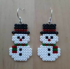 the earrings are made out of legos and have snowmen on them, as well as beads