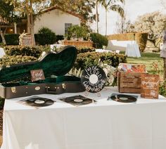 an open suitcase sitting on top of a table next to some cards and other items