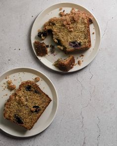 two white plates topped with slices of blueberry bread