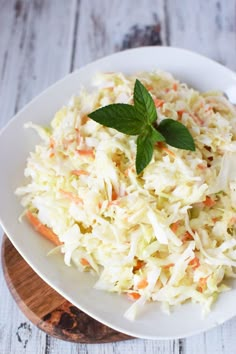 a white plate topped with coleslaw and carrots