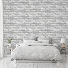 a white brick wall in a bedroom with a bed and two nightstands next to it