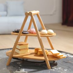 a small wooden shelf with cheese and crackers on it