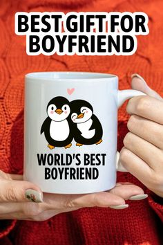 a woman holding a coffee mug with two penguins on it and the words best gift for boyfriend