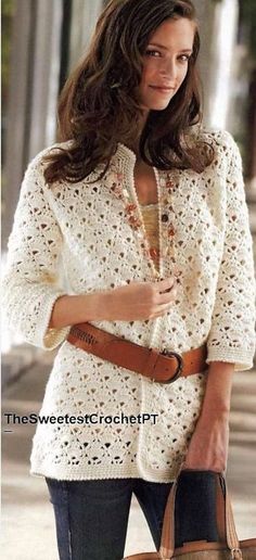 a woman holding a brown purse and wearing a white crochet jacket with pockets