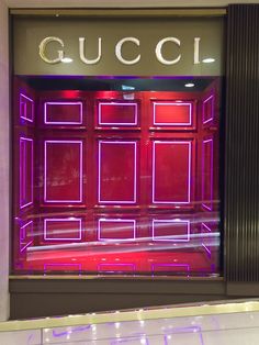 a gucci store front with purple and red lights