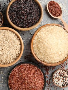 four bowls filled with different types of rice