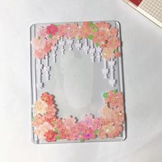 an altered photo frame with flowers on it