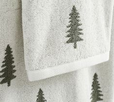 two white towels with black trees on them