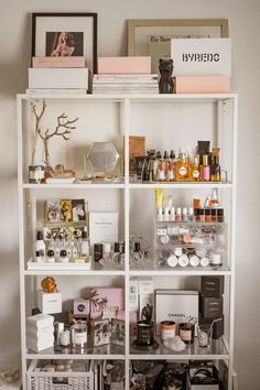 a white shelf filled with lots of different types of cosmetics and personal care items on top of it