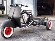 a scooter parked in front of a garage door with the back wheels down