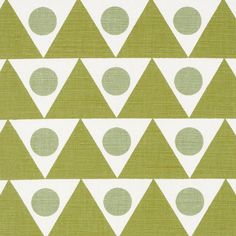 a green and white fabric with small dots on the top of it, in rows of triangles