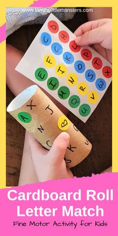 a child holding a roll of paper with letters on it and the words cardboard roll letter match