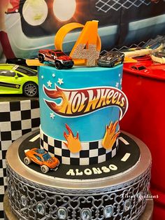 a birthday cake with hot wheels on top