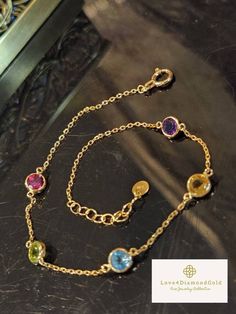 Gift yourself or your loveonce this beautiful Dainty Gem Bracelet. Set in 18 Karat of Gold. * Materials: 18Karat Gold, Citrine, Amethyst, Blue Topaz, Pink Sapphire, Peridot * Gold Color: Yellow Gold * Chain Length: 6.5 Inches-7.5 Inches (Adjustable) * Chain Width: .9mm *Gem Width: 4.6mm * 5 Gemstones * Weight: 1.32grams 💎 NOT Gold Plated; Not Gold Filled. *Some photos might be enlarged to get an accurate description and image. Pls see the item's description before checking out. 💥PLS FOLLOW US Cubic Zirconia Bracelets With Gemstone Accents Gift, Elegant Cubic Zirconia Bracelet With Birthstone, Fine Jewelry Bracelets With Stones As Gift, Fine Jewelry Bracelets With Stones For Gift, Elegant Crystal Bracelet With Birthstone For Anniversary, Elegant Birthstone Bracelets As Gift For Her, Elegant Birthstone Bracelet As A Gift For Her, Elegant Crystal Birthstone Bracelet For Anniversary, Elegant Birthstone Crystal Bracelet For Anniversary