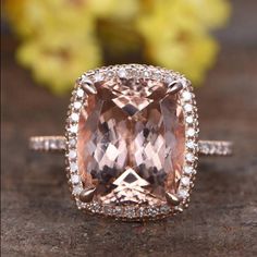 an engagement ring with a fancy cushion cut peach morganite surrounded by diamonds