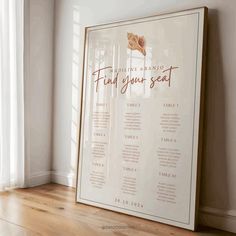 a wedding seating chart is displayed in front of a window