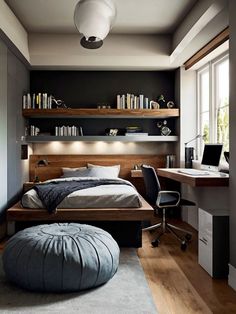 a bedroom with a bed, desk and shelves on the wall next to a window