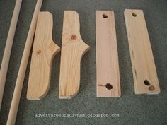 four pieces of wood sitting on top of a floor next to two wooden mallets