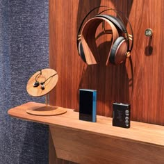 headphones and other electronics are on display in a room with wood paneled walls