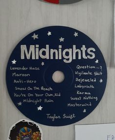 a blue and white disc with the words midnights written on it next to magnets