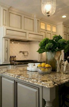 a kitchen with marble counter tops and an island in front of the stove top oven