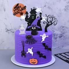 a purple cake decorated with halloween decorations