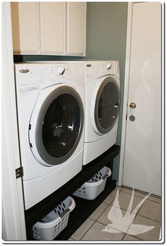 a washer and dryer sitting next to each other in front of a door