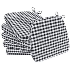 three black and white checkered sheets folded on top of each other, with ties at the ends