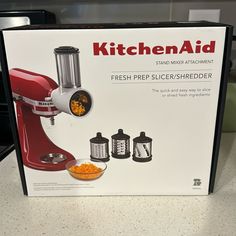 a red kitchen aid blender sitting on top of a counter