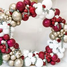 a wreath made out of balloons and christmas decorations