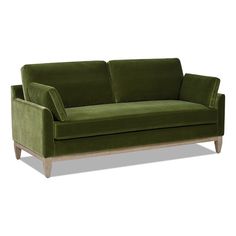 a green velvet couch with wooden legs and arm rests on an isolated white background,