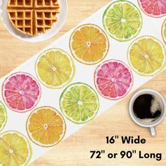 a table topped with waffles and orange slices next to a cup of coffee